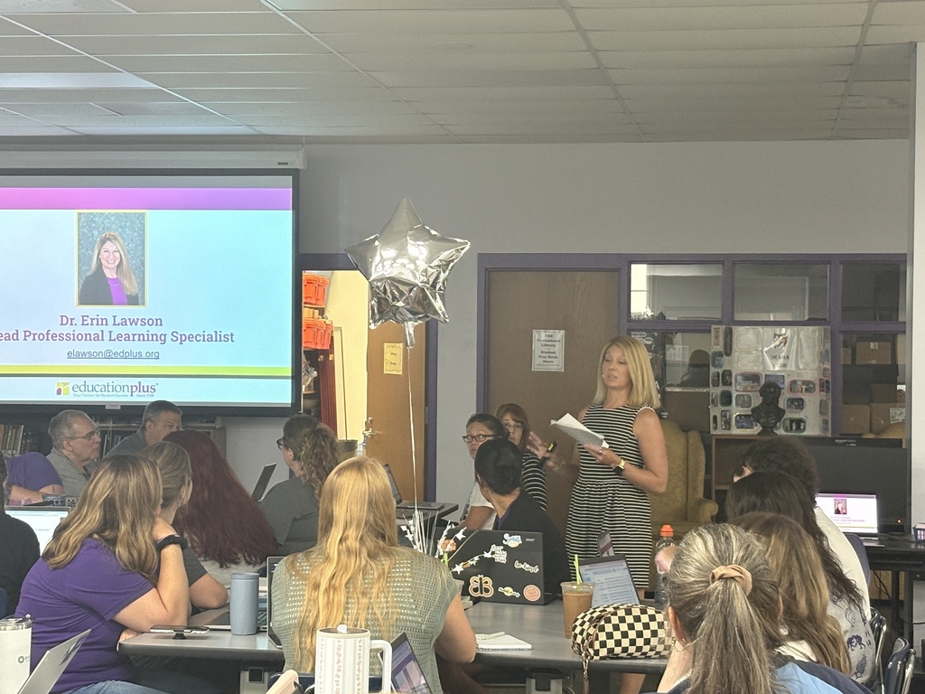 A speaker presenting to a room full of staff.