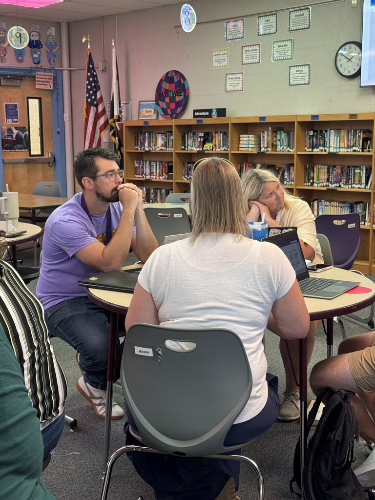 Staff members collaborating in a school library.