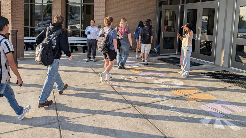 Students walking into a campus building.