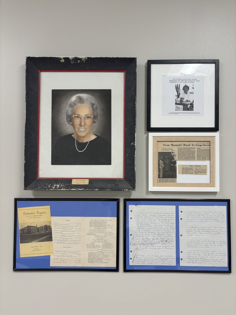 Framed portrait and historical documents honoring Zitzman Elementary’s past, including programs, articles, and handwritten notes.