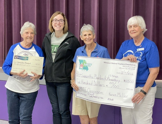 Four women pose with an MRTF Classroom Grant award for $500 presented to educator Samantha Plambeck.