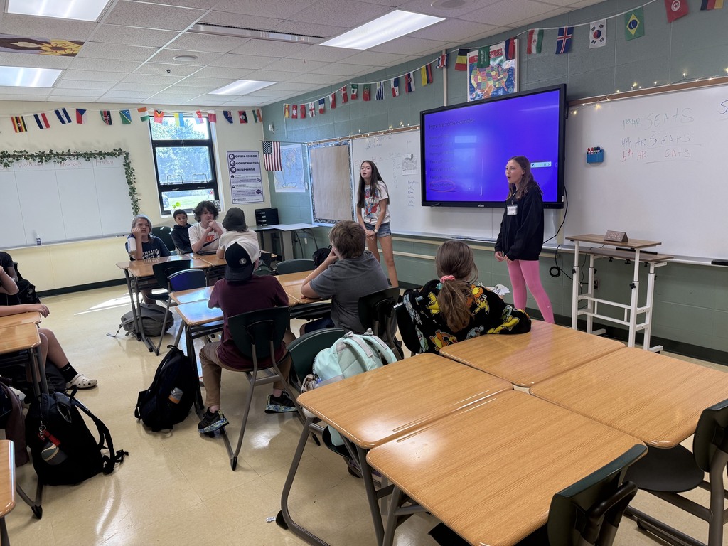 Two older students presenting to a school classroom.
