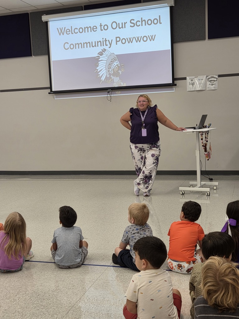 A staff member presenting to a room full of students.