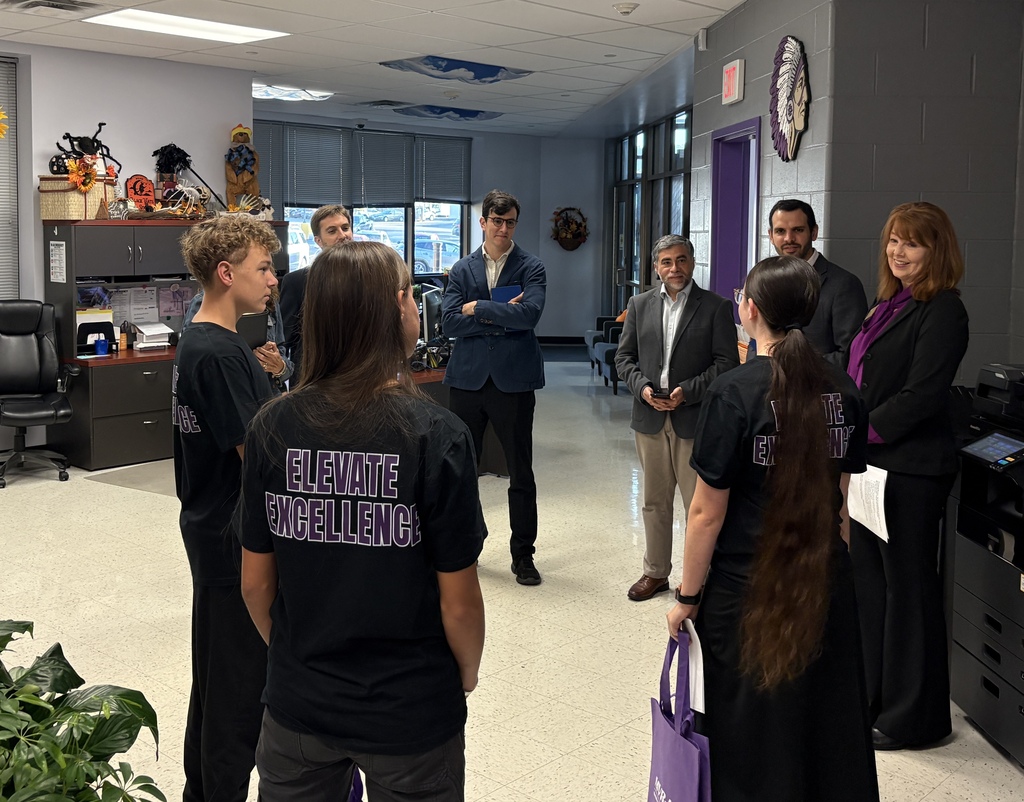 Students and staff members collaborating in a school hallway.
