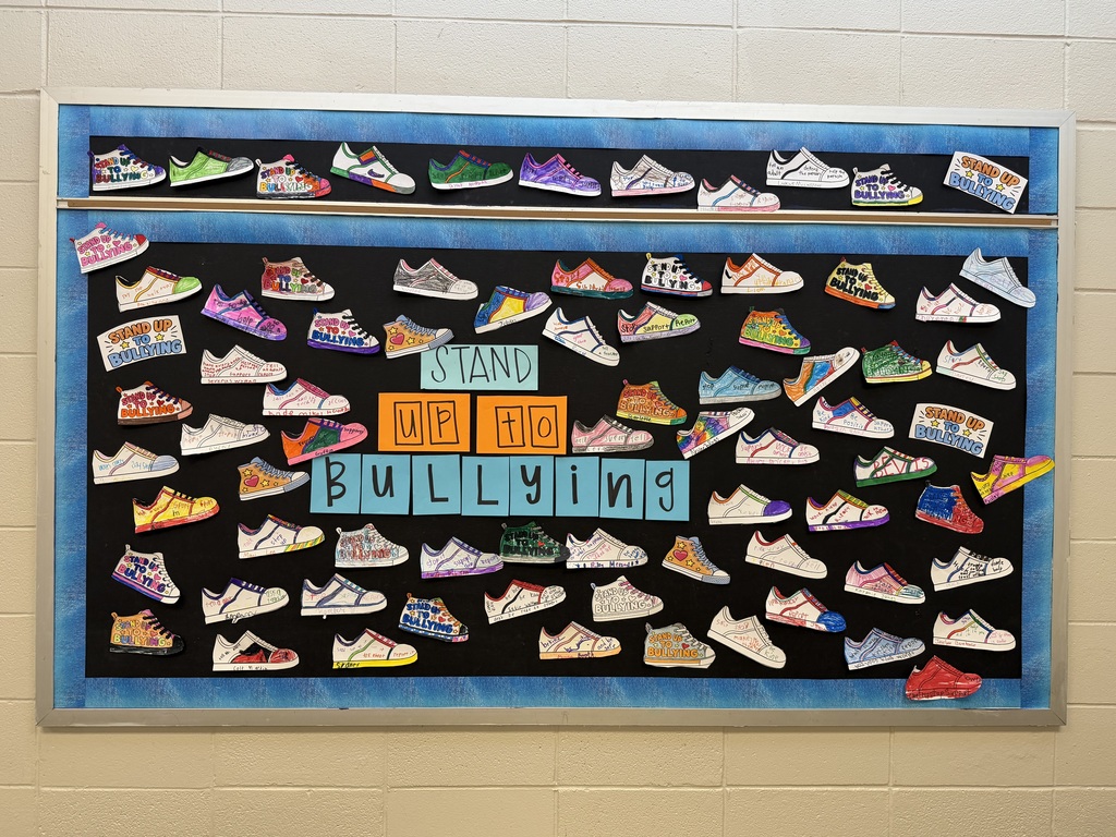 A "Stand up to bullying," student artwork wall display.