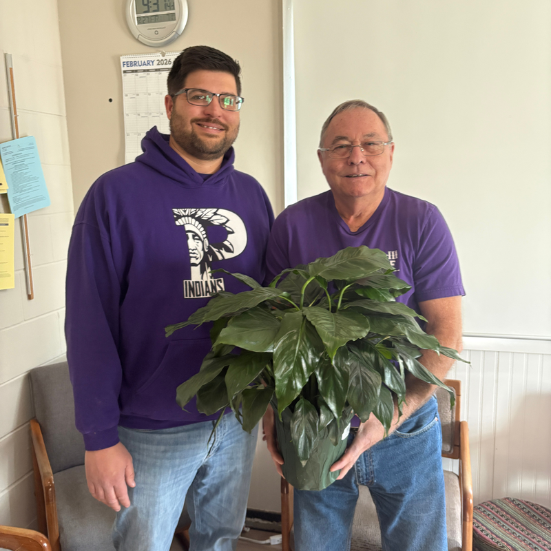 Ed Manuel, Bus Driver holding plant.