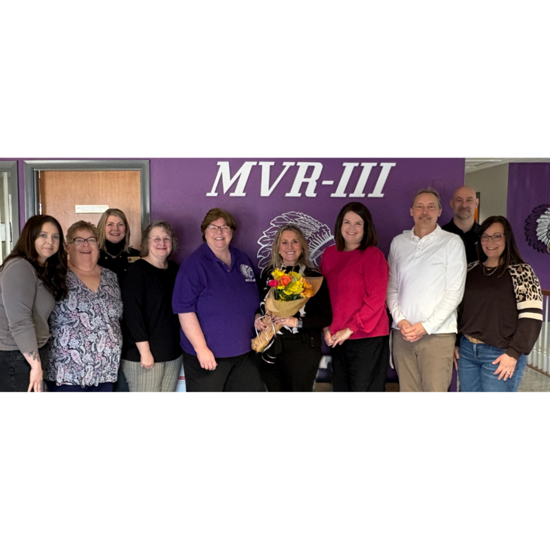 Sarah Thompson, Curriculum & Instruction Coach posing with flowers.