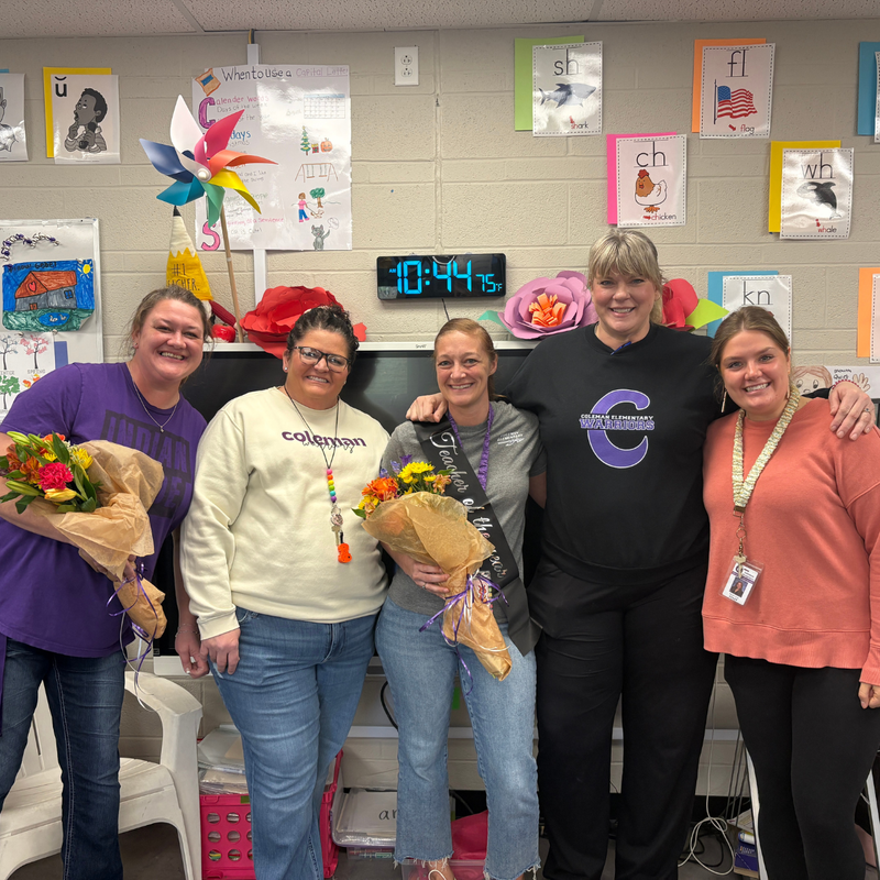 Amanda Peirick, Kindergarten Teacher and Cherie Bowman, Lead Custodian posing in a group photo.