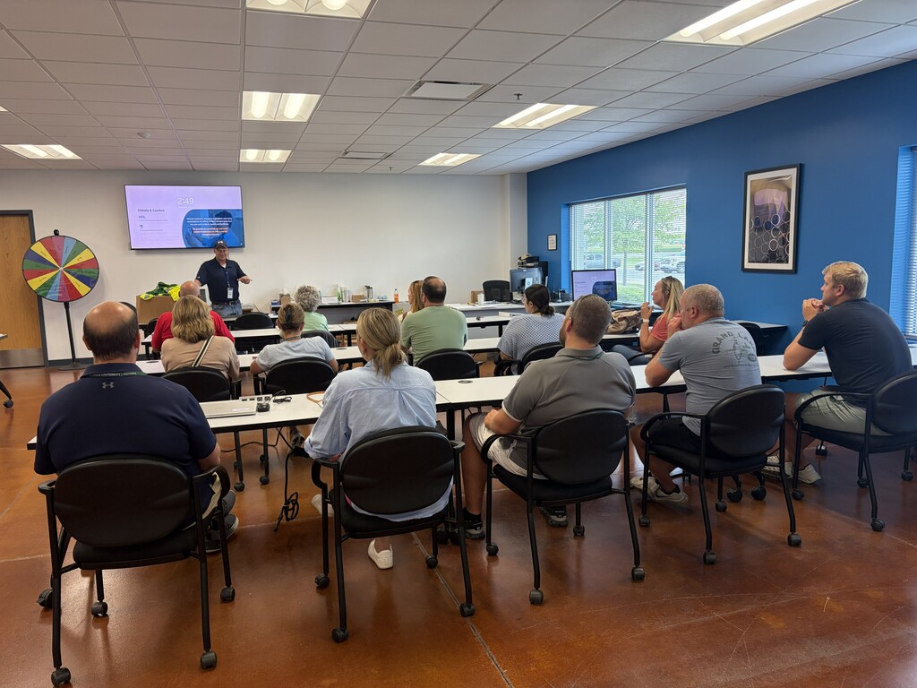Teachers in a room listening to a presenter
