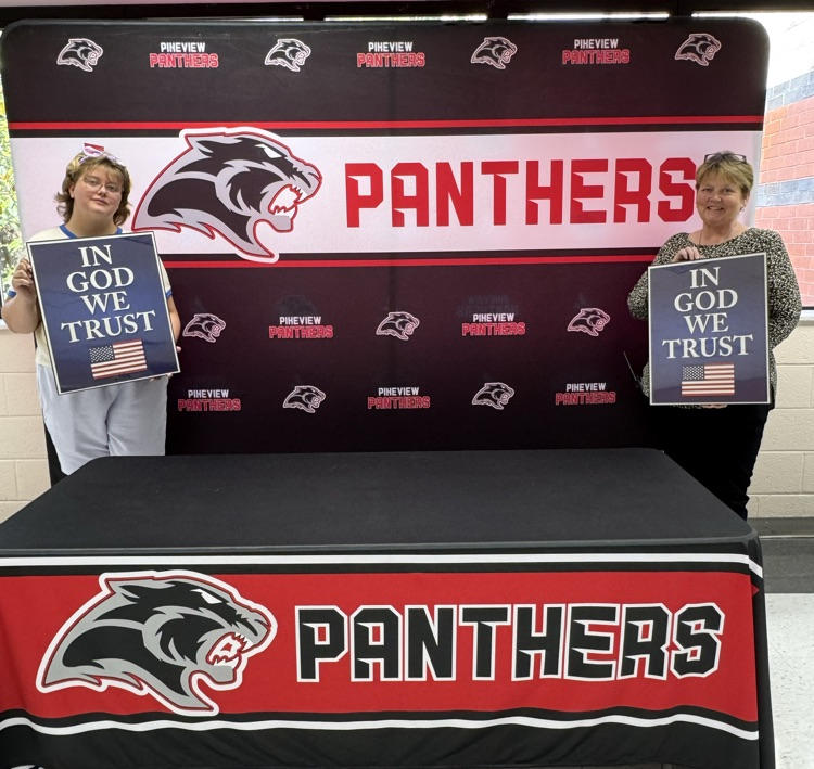 holding In God We trust signs