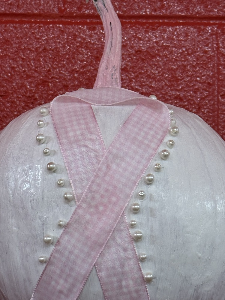 pumpkin with pink and pearl ribbon