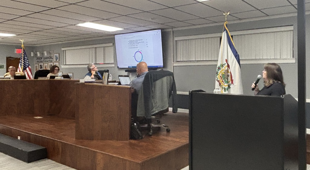 Picture of Amy Harrison presenting information about school calendar requirements at the first of two calendar public hearings.