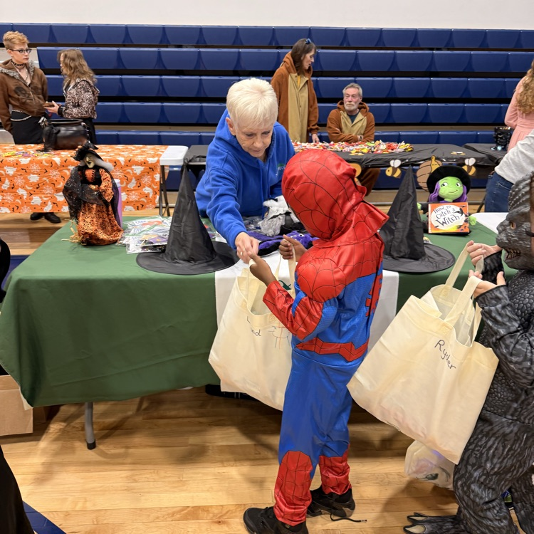 Young boy dressed as spider man trick or treating  