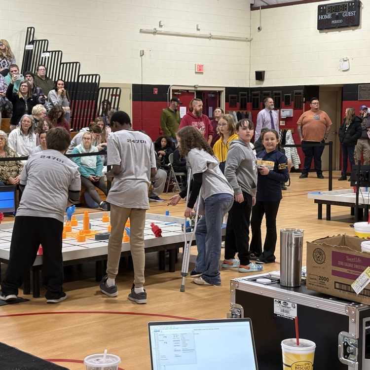2 Mountain Valley students looks back at the camera from the robotics field before their competition started  