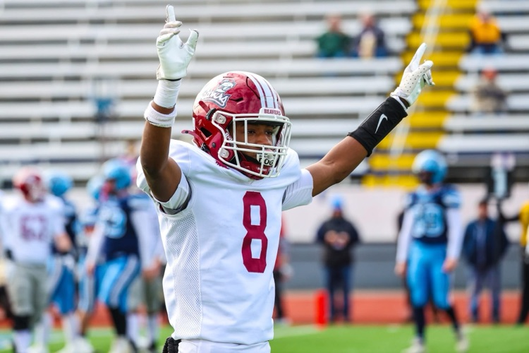 picture of number 8 on the field with his arms raised in triumph