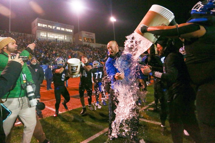 PSHS Coach Tanner being doused with water by the team after the win