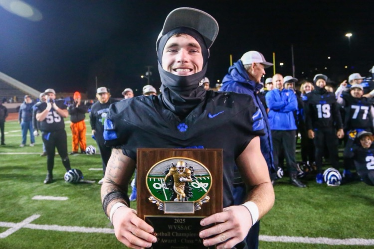 Brad Mossor holding his MVP plaque