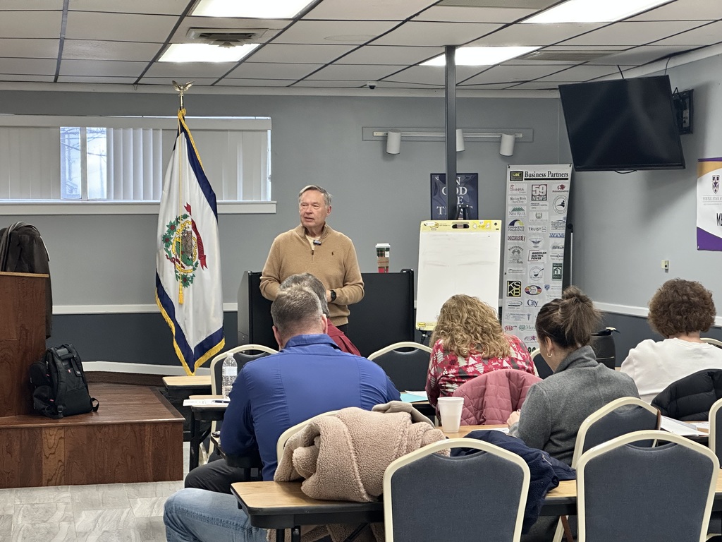 Mr. McClanahan at the front of the room addressing Central Office Staff