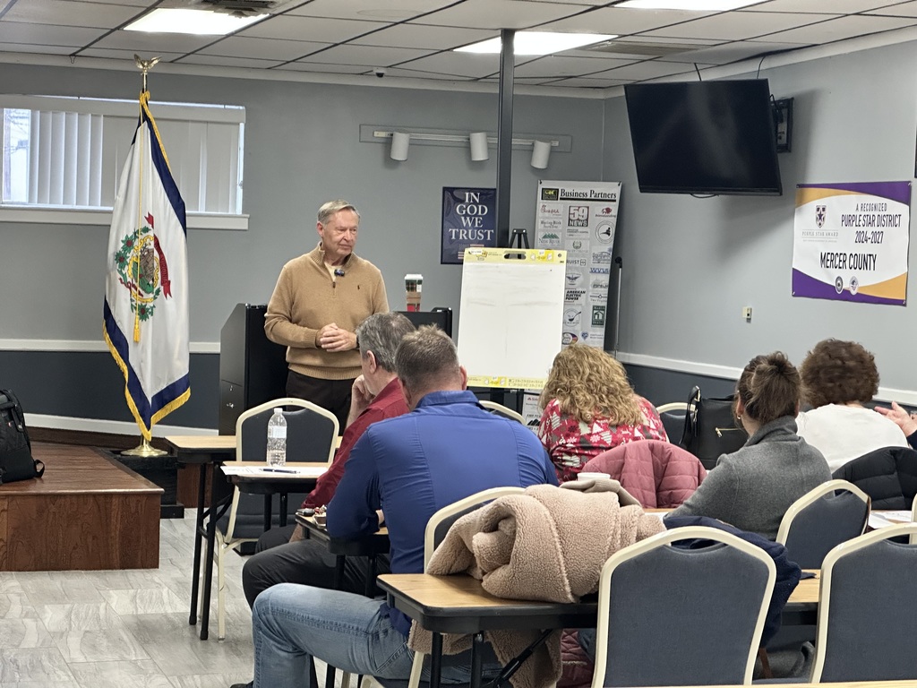 Mr. McClanahan at the front of the room addressing Central Office Staff