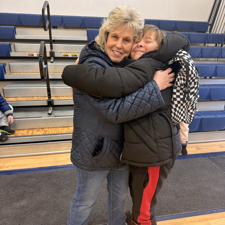 Picture is of school counselor Mrs. Belcher hugging a student. 