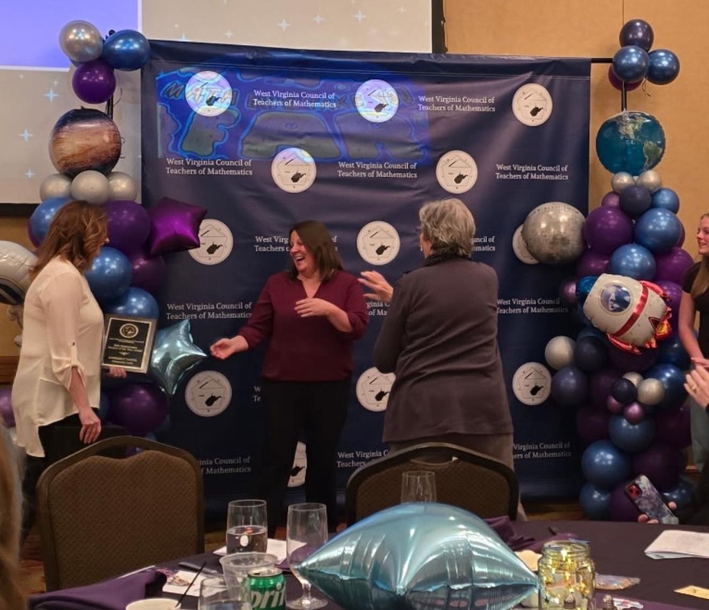 Mrs. Yahya looking surprised and happy at receiving the award.