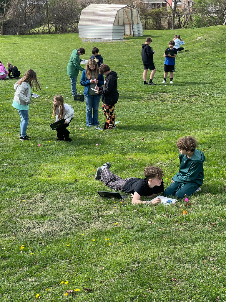 Students in groups solving math problems outside