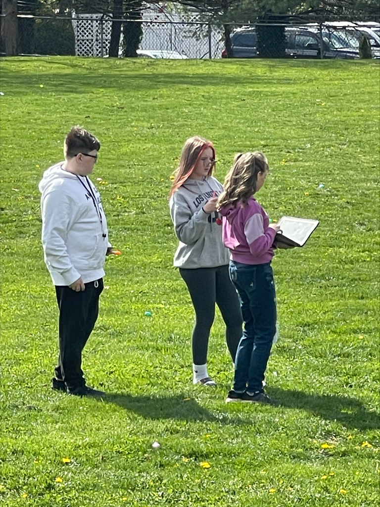Students standing in grass