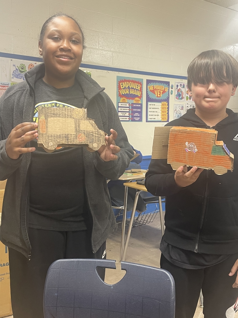 students showing their creations.