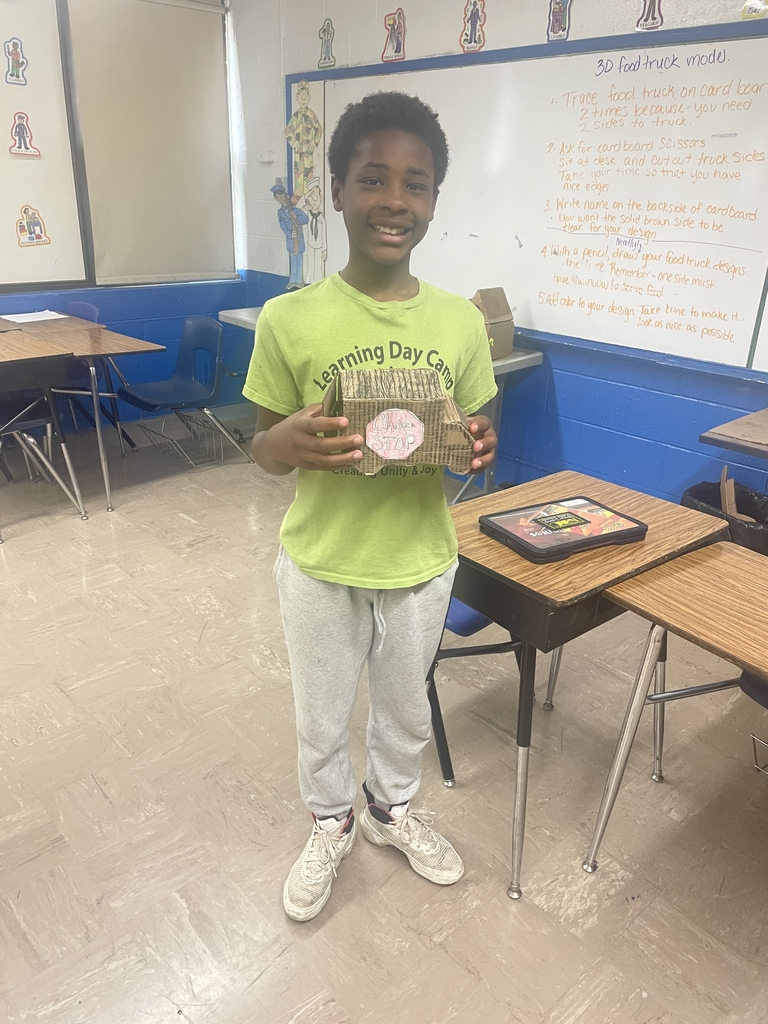 students showing off their creations