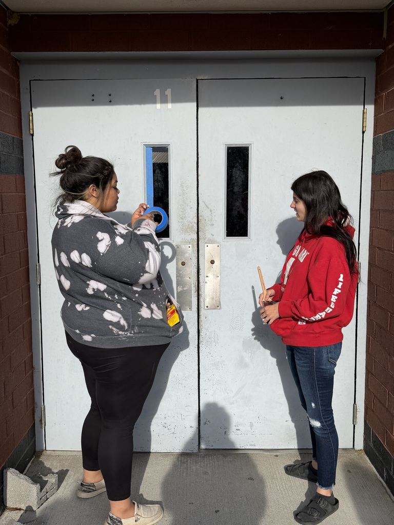 Seniors preparing to paint a door