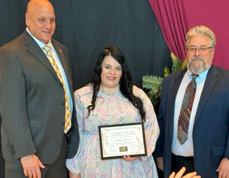 teacher Ashley Bowen with Superintendent Toman and a board of education member  