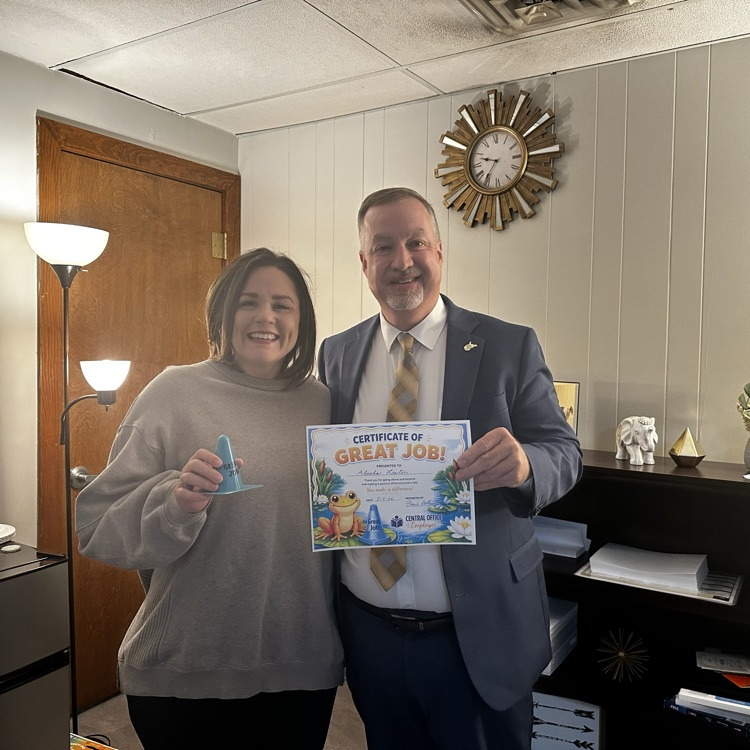 Dr. Adkins giving Alisha Lester a “great job” certificate  