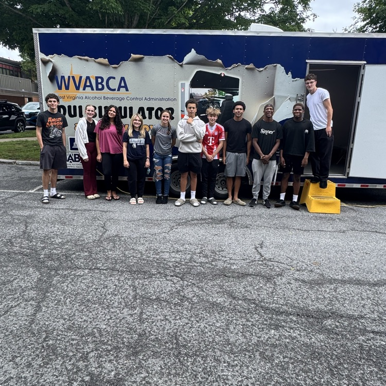 BHS students standing in front of the DUI simulator trailer