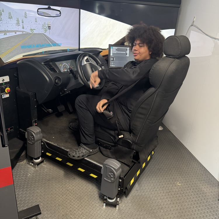 Another student behind the wheel of the simulator