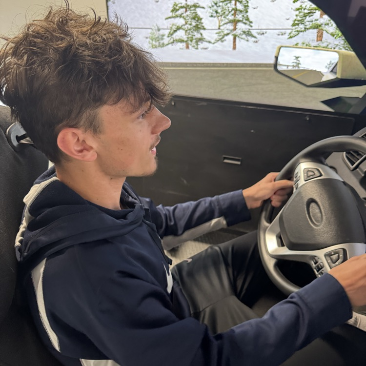 Another student behind the wheel of the simulator