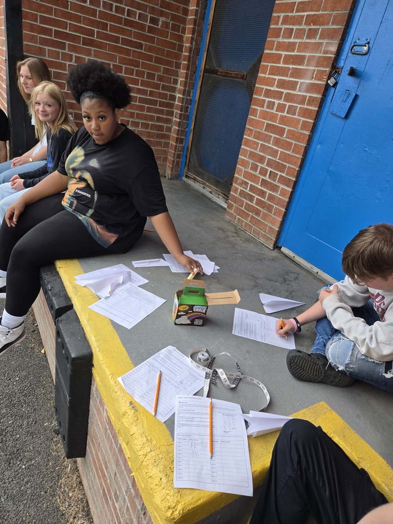 Students with paper airplanes