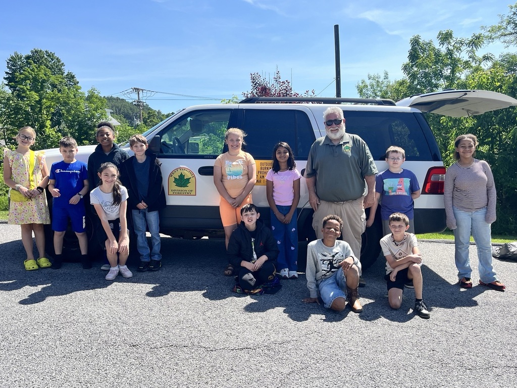 Glenwood students standing with Mr. Sheets in front of a Forestry vehicle.
