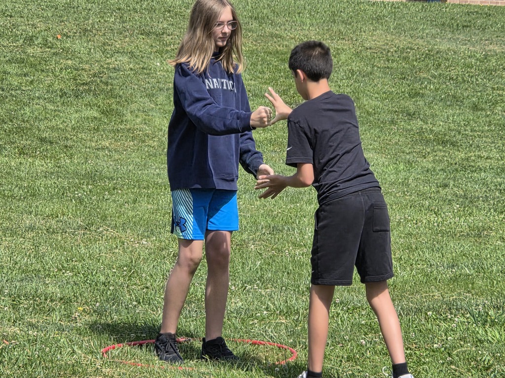 Kids playing rock papwr scissors outside