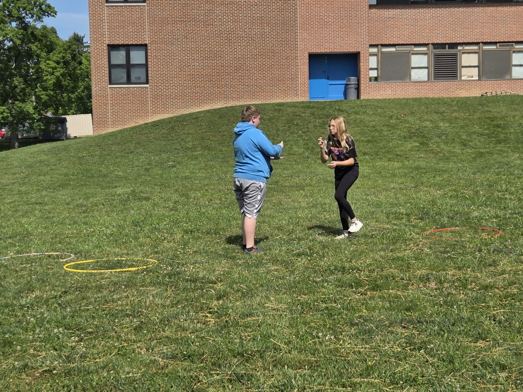 Kids playing rock papwr scissors outside