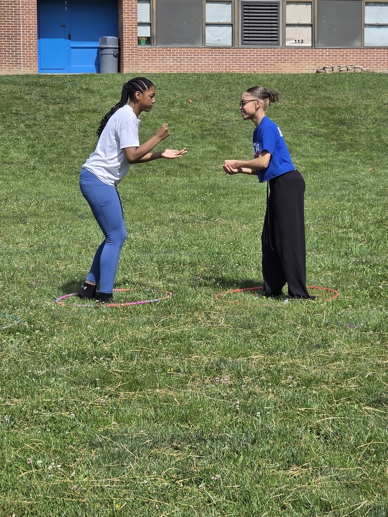 Kids playing rock papwr scissors outside