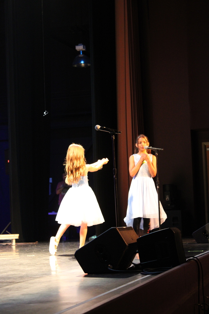 On Thursday, June 11, we had our end-of-year choir performance for grades 3, 4, and 5 at the Chuck Mathena Center.   The students, under the direction of Ms. Ana Barros, performed a beautiful medley of entertaining songs, many of which included choreography. Great job to all involved!  Enjoy looking through all the wonderful pictures from their performance.
