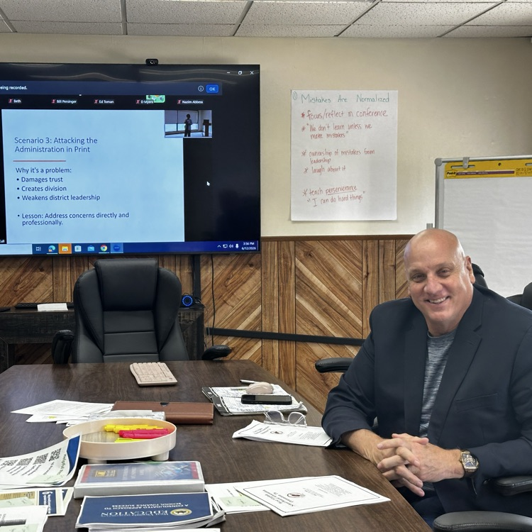 Mr. Toman sitting at a conference room table
