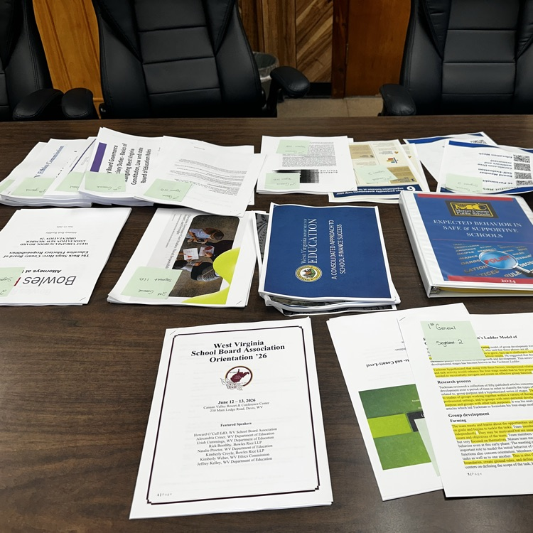 pages of data on the conference room table  