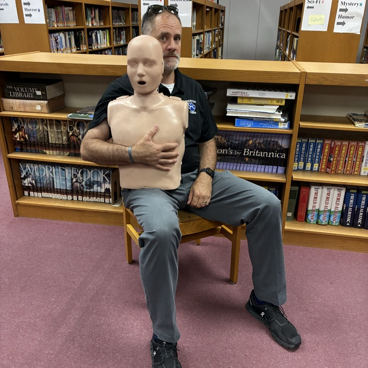 man holding a CPR dummy
