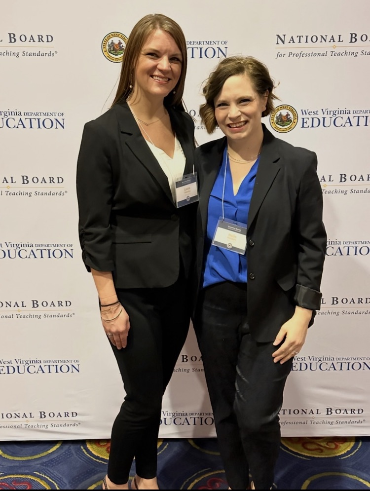 two women standing in front of a WVDE backdrop
