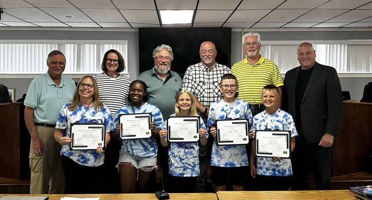 people being recognized by the school board