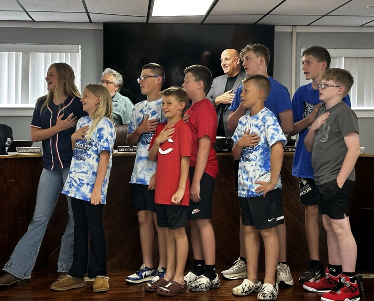 students leading the pledge at the board meeting