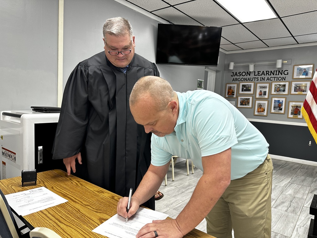 Shawn Vest signing the swearing in form.