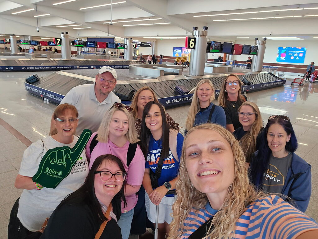 teachers picking luggage at the airport