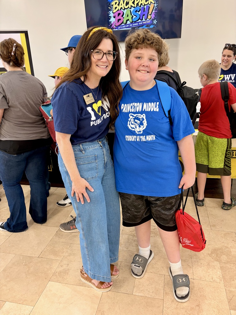 A smiling teacher with a student